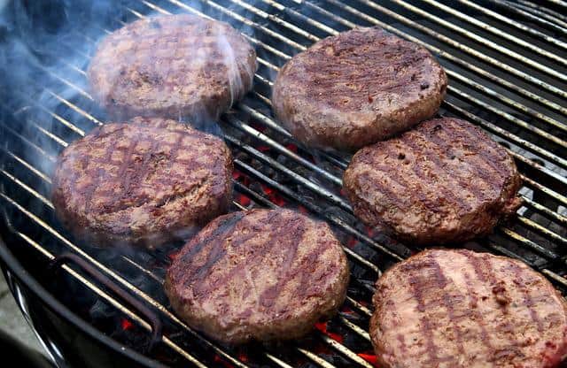 hamburger on grill with smoke