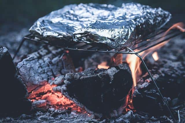 grilling food covered in aluminum foil