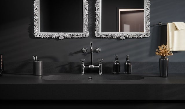 two ornate wall mirrors in black bathroom