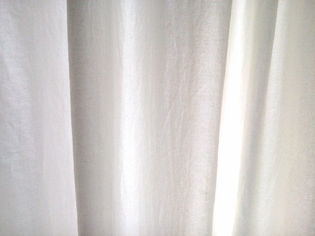 white shower curtain on window